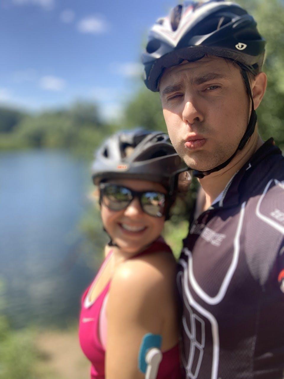 Jessica and her boyfriend posing in cycling helmets